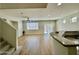Open-concept living room with new floors and staircase, leading to a bright kitchen at 17477 W Woodrow Ln, Surprise, AZ 85388