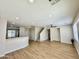 Open-concept living room with recessed lighting, wood-look floors, and stairs at 17477 W Woodrow Ln, Surprise, AZ 85388
