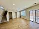 The open living room has a staircase, recessed lighting, and a sliding glass door to the backyard at 17477 W Woodrow Ln, Surprise, AZ 85388