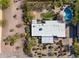 Aerial view of the home featuring a flat roof, desert landscaping, an in-ground pool and perimeter fencing at 1811 E Aurelius Ave, Phoenix, AZ 85020