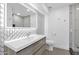 Sleek modern bathroom featuring a large illuminated mirror, vanity, and glass enclosed shower at 1811 E Aurelius Ave, Phoenix, AZ 85020