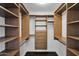 Walk-in closet with ample shelving, drawers, and hanging space for organized storage at 1811 E Aurelius Ave, Phoenix, AZ 85020