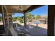 Covered back patio with lounge chairs and an outdoor kitchen for entertaining at 19058 N Aztec Point Dr, Surprise, AZ 85387
