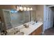 Bathroom with dual sinks, ample counter space, and a view of the shower at 19058 N Aztec Point Dr, Surprise, AZ 85387