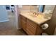 Bathroom sink featuring wood cabinetry, a neutral countertop, and wood flooring at 19058 N Aztec Point Dr, Surprise, AZ 85387