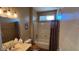 Bathroom features a shower-tub combo, single sink vanity, and neutral tile at 19058 N Aztec Point Dr, Surprise, AZ 85387