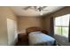 Bedroom offers a ceiling fan, natural light, neutral walls, and carpeted floors at 19058 N Aztec Point Dr, Surprise, AZ 85387