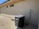 Exterior ground-level view of the house showing the air conditioner and gravel ground at 19058 N Aztec Point Dr, Surprise, AZ 85387