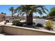 Landscaped front yard features a mature palm tree and colorful shrubbery at 19058 N Aztec Point Dr, Surprise, AZ 85387