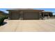 Exterior of the home featuring a three-car garage with a large driveway at 19058 N Aztec Point Dr, Surprise, AZ 85387