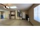 View of an oversized garage with epoxy floor, storage cabinets, and mechanical systems in one corner at 19058 N Aztec Point Dr, Surprise, AZ 85387