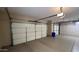 Spacious garage with epoxy flooring, ample storage cabinets, and a clean, organized layout at 19058 N Aztec Point Dr, Surprise, AZ 85387