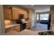 Well-lit kitchen featuring wooden cabinets, stainless steel appliances, and tile backsplash, with an open view to living area at 19058 N Aztec Point Dr, Surprise, AZ 85387