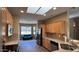 Well-lit kitchen featuring wooden cabinets, stainless steel appliances, and tile backsplash, with an open view to living area at 19058 N Aztec Point Dr, Surprise, AZ 85387