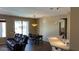 Cozy living and dining area featuring tile flooring, a dark dining set, and outdoor views at 19058 N Aztec Point Dr, Surprise, AZ 85387