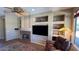 Inviting living room showcasing a fireplace, custom shelving, comfortable seating, and sunlit windows at 19058 N Aztec Point Dr, Surprise, AZ 85387