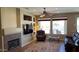 Inviting living room showcasing a fireplace, custom shelving, comfortable seating, and sunlit windows at 19058 N Aztec Point Dr, Surprise, AZ 85387