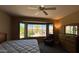 Comfortable main bedroom features a ceiling fan, bay window and backyard views at 19058 N Aztec Point Dr, Surprise, AZ 85387