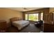 Spacious bedroom with a bay window and a comfortable chair at 19058 N Aztec Point Dr, Surprise, AZ 85387