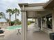 Relaxing covered patio overlooking the pool and lush backyard with seating at 19058 N Aztec Point Dr, Surprise, AZ 85387
