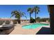Private backyard oasis with a sparkling pool, hot tub, and lush landscaping at 19058 N Aztec Point Dr, Surprise, AZ 85387