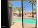 Relaxing poolside view featuring a refreshing pool and mature palm trees at 19058 N Aztec Point Dr, Surprise, AZ 85387