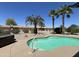 Clear, refreshing pool complemented by palm trees and desert landscaping for a backyard oasis at 19058 N Aztec Point Dr, Surprise, AZ 85387