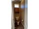 A cozy water closet featuring a wood-seat toilet and a storage cabinet at 19058 N Aztec Point Dr, Surprise, AZ 85387