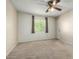 Well-lit bedroom with neutral carpet, ceiling fan, and window with curtains at 1942 S Emerson -- # 219, Mesa, AZ 85210