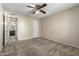 Neutral bedroom featuring beige carpet, ceiling fan, and an open doorway at 1942 S Emerson -- # 219, Mesa, AZ 85210