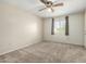 Spacious bedroom with neutral carpet, ceiling fan, and a bright window view at 1942 S Emerson -- # 219, Mesa, AZ 85210