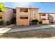 A two-story condo with tan stucco, red roof tiles, and walkways surrounded by neat landscaping at 1942 S Emerson -- # 219, Mesa, AZ 85210