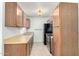 Efficient kitchen featuring wood-style cabinets, stainless steel appliances and sink at 1942 S Emerson -- # 219, Mesa, AZ 85210
