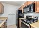 Close-up view of the kitchen's stainless steel appliances and wood-style cabinets at 1942 S Emerson -- # 219, Mesa, AZ 85210