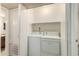 Laundry room with white washer and dryer next to shelves at 1942 S Emerson -- # 219, Mesa, AZ 85210