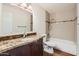 Bathroom featuring granite counters, new floors, and shower over tub at 2021 W Clarendon Ave, Phoenix, AZ 85015