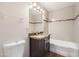 Bathroom featuring vanity with granite countertop and tiled shower at 2021 W Clarendon Ave, Phoenix, AZ 85015