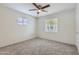 Carpeted bedroom with natural light from two windows and ceiling fan at 2021 W Clarendon Ave, Phoenix, AZ 85015
