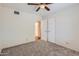 Carpeted bedroom with ceiling fan and closets at 2021 W Clarendon Ave, Phoenix, AZ 85015