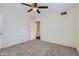 Bright carpeted bedroom featuring ceiling fan and closet at 2021 W Clarendon Ave, Phoenix, AZ 85015