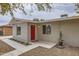 Charming single-story home featuring desert landscaping and a bright red front door at 2021 W Clarendon Ave, Phoenix, AZ 85015