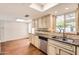 Bright eat-in kitchen featuring stainless dishwasher, granite counters, and tiled backsplash at 2021 W Clarendon Ave, Phoenix, AZ 85015