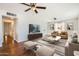 Staged living room featuring hardwood floors, ceiling fans, and neutral furniture at 2021 W Clarendon Ave, Phoenix, AZ 85015