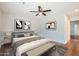 Bright staged main bedroom featuring modern decor, a ceiling fan and warm hardwood floors at 2021 W Clarendon Ave, Phoenix, AZ 85015
