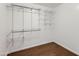 Organized walk-in closet with shelves and rods for ample storage at 2021 W Clarendon Ave, Phoenix, AZ 85015