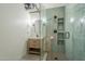 Bright bathroom with modern vanity, glass enclosed shower and open shelving at 21 E 6Th St # 311, Tempe, AZ 85281