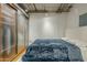 Loft-style bedroom with frosted closet doors, industrial ceiling and warm wood floors at 21 E 6Th St # 311, Tempe, AZ 85281