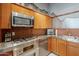 Kitchen boasts stainless appliances, stainless counters, brick backsplash and light wood cabinets at 21 E 6Th St # 311, Tempe, AZ 85281