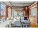 Bright living room with open shelving, exposed brick, ductwork, and hardwood floors at 21 E 6Th St # 311, Tempe, AZ 85281
