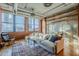 Bright living room with exposed ductwork, brick accent wall, and city views from large windows at 21 E 6Th St # 311, Tempe, AZ 85281